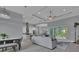 Open living room with a view of the pool and kitchen at 111 Long Meadow Ln, Rotonda West, FL 33947