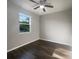 Well-lit bedroom with hardwood floors and a ceiling fan at 11516 Palmetto Sands Ct, Tampa, FL 33626