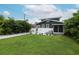 Spacious backyard featuring a green lawn, white fence, and a cozy screened porch at 236 20Th Ave Se, St Petersburg, FL 33705