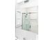 Contemporary bathroom with glass-enclosed shower, chrome fixtures, and white tile throughout at 236 20Th Ave Se, St Petersburg, FL 33705