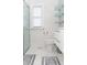 Modern bathroom featuring glass shower, white toilet, vanity, tile floors, and linen closet at 236 20Th Ave Se, St Petersburg, FL 33705