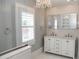 Elegant bathroom with a chandelier, double sink vanity, and stylish tiled walls at 236 20Th Ave Se, St Petersburg, FL 33705