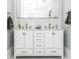 Bright bathroom featuring a double sink vanity with white cabinets and decorative mosaic backsplash at 236 20Th Ave Se, St Petersburg, FL 33705
