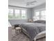 Bright bedroom featuring three windows, neutral decor, and a comfortable king-size bed at 236 20Th Ave Se, St Petersburg, FL 33705