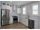 Bright kitchen with stainless appliances, white cabinetry, stylish backsplash, and hardwood flooring at 236 20Th Ave Se, St Petersburg, FL 33705