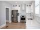 Charming kitchen featuring stainless steel appliances, white cabinets, and eye-catching patterned backsplash at 236 20Th Ave Se, St Petersburg, FL 33705