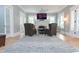 Spacious living room with a decorative fireplace, light hardwood floors, and comfortable seating at 236 20Th Ave Se, St Petersburg, FL 33705
