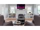 Cozy living room highlighting the fireplace, built-in shelving, and bright windows at 236 20Th Ave Se, St Petersburg, FL 33705