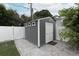 Backyard shed features gray siding, a white door and a paved patio area at 236 20Th Ave Se, St Petersburg, FL 33705