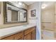Bathroom featuring vanity with light countertop, wooden cabinetry, and a mirror at 6219 Palma Del Mar S Blvd # 301, St Petersburg, FL 33715