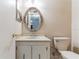 Bathroom with white vanity, toilet, and oval mirror at 6219 Palma Del Mar S Blvd # 301, St Petersburg, FL 33715