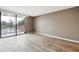 Spacious bedroom with sliding glass doors leading to a balcony, featuring wood-look floors at 6219 Palma Del Mar S Blvd # 301, St Petersburg, FL 33715