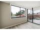 Empty bedroom with sliding glass doors to a balcony and new wood-look flooring at 6219 Palma Del Mar S Blvd # 301, St Petersburg, FL 33715