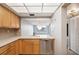 Kitchen with light wood cabinets, double sink, and pass-through window to dining area at 6219 Palma Del Mar S Blvd # 301, St Petersburg, FL 33715