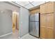 Kitchen with stainless steel refrigerator and wood cabinetry at 6219 Palma Del Mar S Blvd # 301, St Petersburg, FL 33715