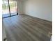 Spacious living room featuring new wood-look flooring and sliding glass doors to balcony at 6219 Palma Del Mar S Blvd # 301, St Petersburg, FL 33715