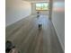 Large living room with new wood-look floors and large window at 6219 Palma Del Mar S Blvd # 301, St Petersburg, FL 33715