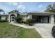 Single-story house with a two-car garage and landscaping at 4495 Amari Rd, North Port, FL 34291