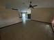 Open living room with tile floors and a view into the kitchen at 4495 Amari Rd, North Port, FL 34291