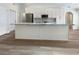 Modern kitchen with white cabinets, granite island, and stainless steel appliances at 26119 Constantine Rd, Punta Gorda, FL 33983