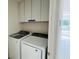 Laundry room with washer and dryer, and overhead cabinets at 18313 Garman Ave, Port Charlotte, FL 33948