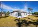 Spacious backyard featuring a concrete patio and plenty of green space at 18059 Regan Ave, Port Charlotte, FL 33948