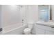 Clean bathroom with a tub, toilet and sink at 18059 Regan Ave, Port Charlotte, FL 33948