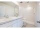 Bright bathroom features double sink vanity, toilet, and walk-in shower with white subway tile surround at 18059 Regan Ave, Port Charlotte, FL 33948