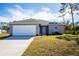 Charming one-story home with a large driveway and well-maintained lawn at 18059 Regan Ave, Port Charlotte, FL 33948