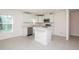 Well-lit kitchen with modern fixtures, stainless appliances, and island at 18059 Regan Ave, Port Charlotte, FL 33948
