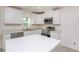 Modern kitchen with stainless steel appliances, white cabinets, and island at 18059 Regan Ave, Port Charlotte, FL 33948