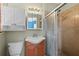 Bathroom features wooden vanity with tiled shower, medicine cabinet, and ample lighting at 1023 Madison St, Largo, FL 33770