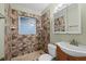 Full bathroom featuring wooden vanity with shower, and earthy-toned tile accents at 1023 Madison St, Largo, FL 33770