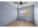 Cozy bedroom featuring tiled flooring, ceiling fan, and large window for natural light at 1023 Madison St, Largo, FL 33770