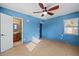 Blue main bedroom featuring an ensuite bathroom, ceiling fan, and tile flooring at 1023 Madison St, Largo, FL 33770