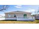 Rear exterior of a home featuring a white back patio overlooking the lawn at 17384 Robinson Ave, Port Charlotte, FL 33948