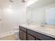 Bright bathroom featuring double sinks, dark cabinets, and a stand-up shower at 17384 Robinson Ave, Port Charlotte, FL 33948