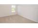 Cozy bedroom with plush carpet and a window offering natural light at 17384 Robinson Ave, Port Charlotte, FL 33948