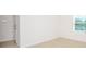 A sunlit empty bedroom featuring neutral colors and tiled floor at 17384 Robinson Ave, Port Charlotte, FL 33948