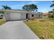 Newly renovated home with a gray exterior and white garage door at 1340 Redstart Rd, Venice, FL 34293