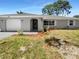 Newly renovated home with gray exterior and landscaping at 1340 Redstart Rd, Venice, FL 34293