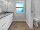 Main bathroom with double vanity and separate toilet area at 1340 Redstart Rd, Venice, FL 34293