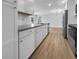 Modern kitchen with gray countertops and white cabinets at 1340 Redstart Rd, Venice, FL 34293