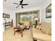 Living room with beige sofas, coffee table, and sliding glass doors at 2111 Tetley Ct, Brandon, FL 33510