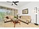 Living room with beige sofas, coffee table, and sliding glass doors at 2111 Tetley Ct, Brandon, FL 33510