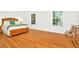 Light and airy bedroom with wood floors and a dresser at 2111 Tetley Ct, Brandon, FL 33510