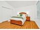 Bedroom with wood floors, a wood bed frame, and built-in closet at 2111 Tetley Ct, Brandon, FL 33510