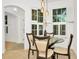 Bright dining area with glass table and four chairs and access to entry way at 2111 Tetley Ct, Brandon, FL 33510