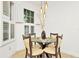 Small dining area with glass table and four chairs near a window at 2111 Tetley Ct, Brandon, FL 33510