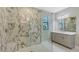 Luxurious bathroom features a marble-tiled walk-in shower and a sleek vanity at 4990 Fairhope Cir, Lakewood Ranch, FL 34211
